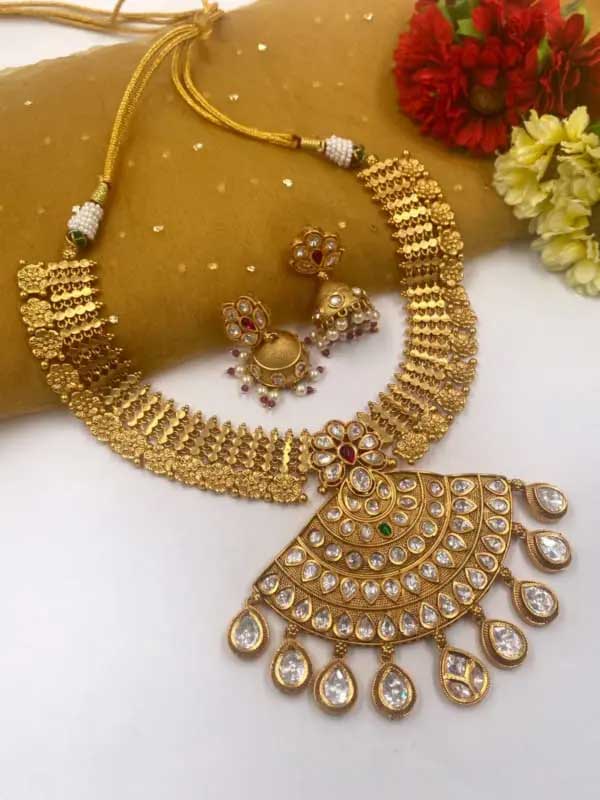 Traditional handcrafted gold-plated latest golden Necklace set from the house of the Gehna Shop.