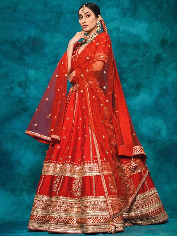 Product Details:

Lehenga Choli Color: Red
Dupatta Color: Red
Lehenga Fabric: Raw Silk
Dupatta Fabric: Net
Work: Zari Sequence and Zardozi Work
Other details:  Bridal lehenga
Blouse Padding : Yes
Neckline: V neck
Sleeve type: ¾ sleeves
Inner / Lining : Attached 
Measurement: Customized in your size