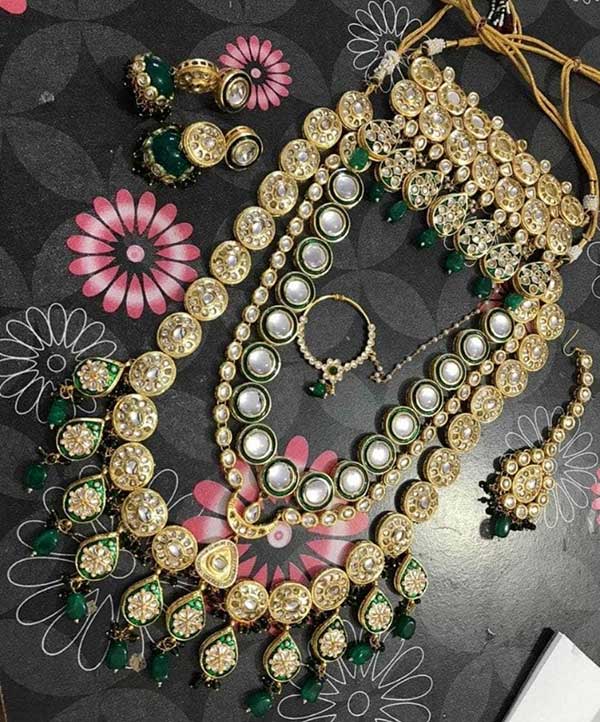 This jewellery set consists of a Bridal Necklace and a pair of earrings
Set of two Gold-plated necklaces with kundan studded detail, secured with drawstring closure
Set of two drop earrings, secured with post and back closure
Gold-plated Kundan nosepin with textured detail, has a beaded chain extension ,secured with S-hook closure
Gold-toned kundan studded bridal Heavy Maangtikka