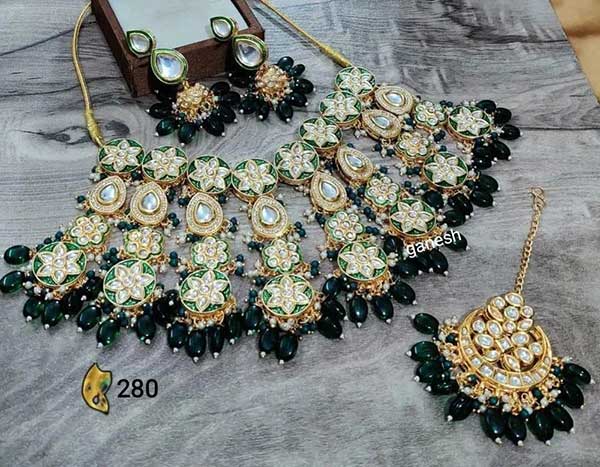 This Jewellery Set Consists Of A Kundan Necklace And Earrings

Gold-Plated Antique Kundan Stone-Studded Necklace With Beaded Detail has Multiple Hanging Stones, Secured With A Drawstring Closure

A Pair Of Matching Drop Earrings, Secured With Post-And-Back Closure by Zevar