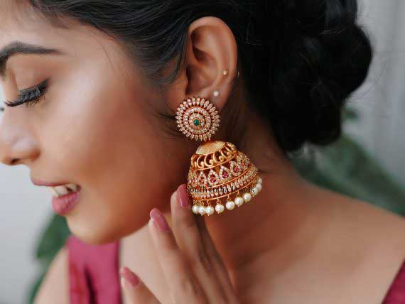 Traditional Jhumkas of gold and bridal stone
