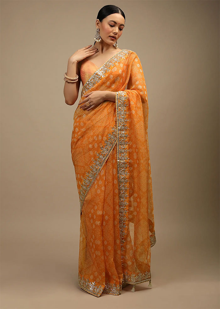 Tangerine saree in organza with bandhani print in floral and geometric motifs along with gotta patti accented border